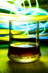 A glass or goblet of cognac with bokeh effect.