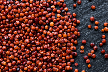 Quinoa seeds on black slate background, macro, top view