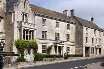 Picturesque Cotswold stone houses on the main street through Painswick, Gloucestershire, UK