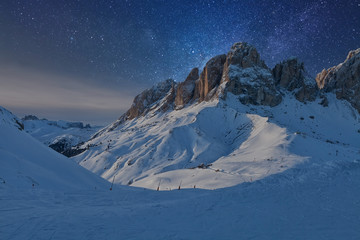 Fototapeta na wymiar Fantastic starry sky. View of the Sassolungo (Langkofel) Group of the Italian Dolomites under starry light