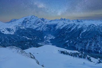 Obraz premium Fantastic starry sky. Panoramic view of the Val Di Fassa ski resort of the Italian Dolomites under starry light