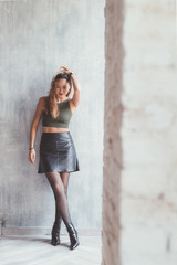 young woman indoors posing looking away - attitude, blogger, influencer concept