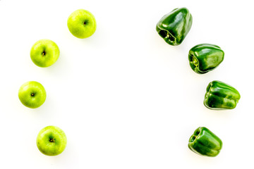 Green vegetables pattern. Shiny bell pepper and fresh apple on white background top view copy space