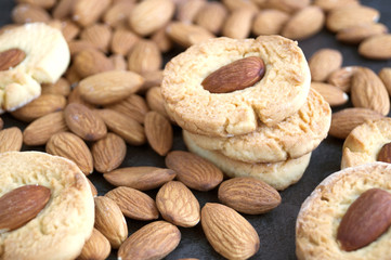 Homemade cookies with almonds on a dark background.