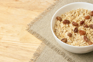 Neutral background. Delicious healthy breakfast. Oatmeal with raisins