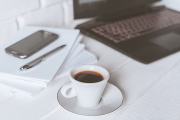 Stylish workspace with notebook, cup of coffee, paper blank, pencils. Business concept. Flat lay, top view.