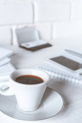Stylish workspace with notebook, cup of coffee, paper blank, pencils. Business concept. Flat lay, top view.
