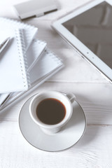 Stylish workspace with notebook, cup of coffee, paper blank, pencils. Business concept. Flat lay, top view.