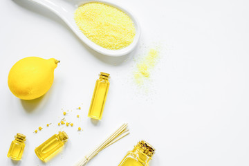 Cosmetic set from salt, oils and lemon white background top view