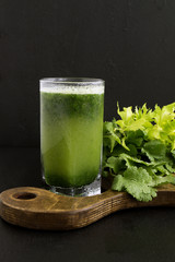 Fresh juice of celery on a black background