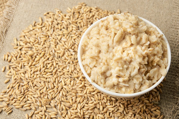 Raw porridge. Useful cooked porridge. Neutral light background