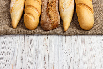 Homemade baguettes on wooden table. close up