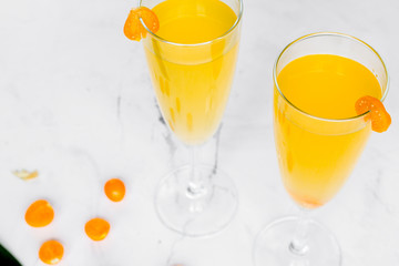 cocktail with physalis in glass on stone background