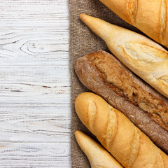Homemade baguettes on wooden table. close up