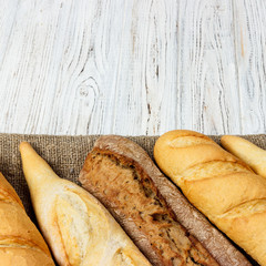 Homemade baguettes on wooden table. close up