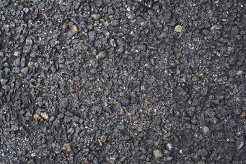 Uneven black surface. Dark asphalt. Paved road