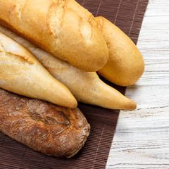 Assortment of fresh French baguettes on a wooden table
