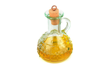 Glass jug with vegetable oil isolated on white .