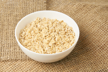 White bowl. Healthy food. Oatmeal porridge. Light background