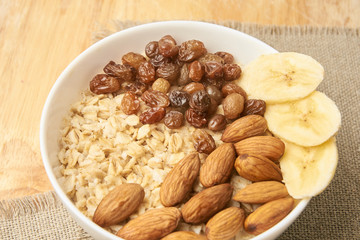 White cup. Oatmeal with raisins banana and almonds