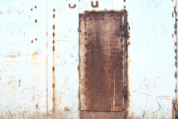 White dirty wall. Old rusty garage door