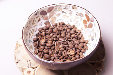 White light background. Coffee beans in a cup