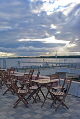 Street open cafe with view at the Volga river, Samara, Russia at sunset. Tables and seats are empty. Romantic evening place.