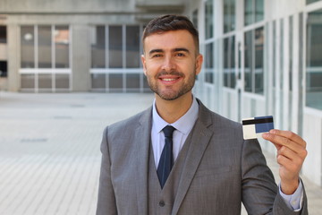 Businessman showing a credit card