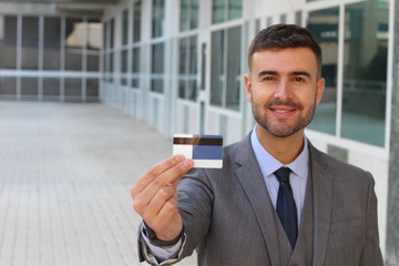 Businessman showing a credit card 