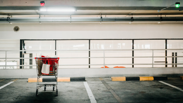 automatic technology check for shopping cart in parking lane and show red light  with soft focus shopping mall background