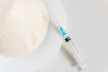 Sugar and syringe. The concept of possible harm from sugar.