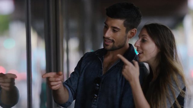 Young attractive couple browsing items through a shop window