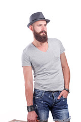 Fototapeta premium Portrait of handsome bearded man in hat standing , isolated on grey background
