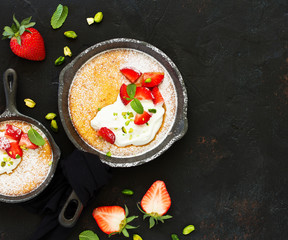 almond pie with cream and strawberries. View from above.