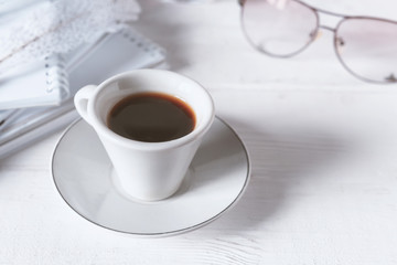 Stylish workspace with notebook, cup of coffee, paper blank, pencils. Business concept. Flat lay, top view.