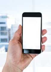 Hand holding phone by window