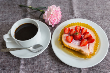 Cake and strawberries on wood background.