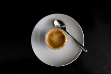 cup of espresso, viewed from above, red cup, straw table, detail