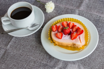 Cake and strawberries on wood background.