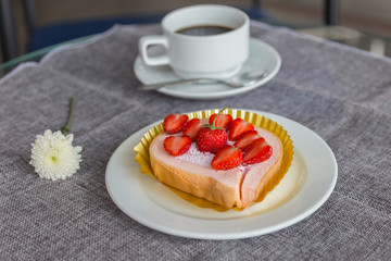 Cake and strawberries on wood background.