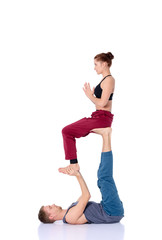 Young athletic couple practicing acroyoga. Balancing in pair