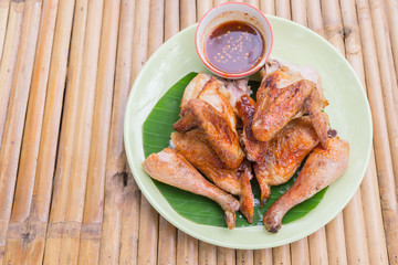 Baked chicken wings in pan on wooden table. 