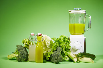 Fresh diet vegetable smoothie on green background
