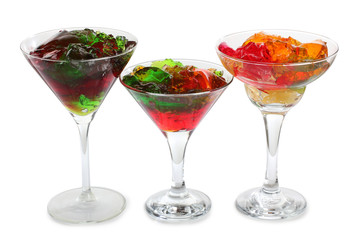Sweet jam and fruit in glass on white background