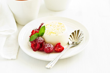 Delicious home-made dessert Panna cotta. Cream-caramel, caramel custard, with raspberries.