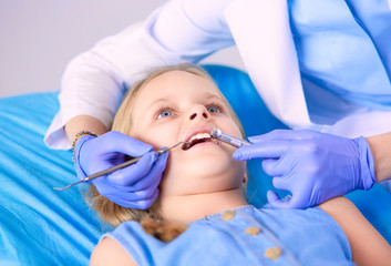 Little girl sitting in the dentists office