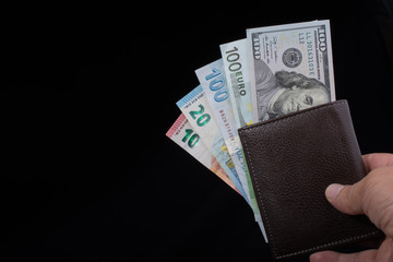 Hand holding American dollar  isolated on black background