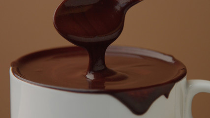 spoon in cup of hot chocolate moving it slowly