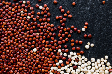 Quinoa seeds on black slate background, macro, top view