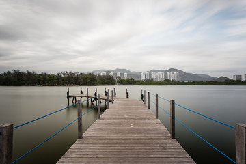 Long exposure of deck in lake, cloudy skies